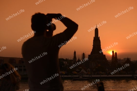 Tourists near the Wat Arun during a rally at theDemocracy Monument in .Bangkok, Thailand, Saturday Jan.11 , 2014.