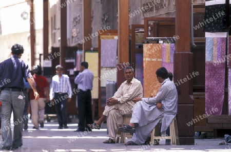 a shopping street in the souq or Market in the old town in the city of Dubai in the Arab Emirates in the Gulf of Arabia.