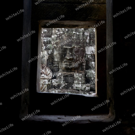 Stone Faces the Tempel Ruin of Angkor Thom in the Temple City of Angkor near the City of Siem Riep in the west of Cambodia.