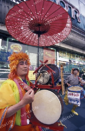 a Music group and a red umbrella in restaurant in the streets in the City centre of Tokyo in Japan in Asia,