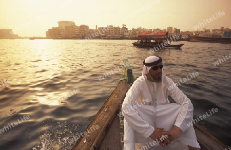 a city boat and ferry on the Dubai creek in the old town in the city of Dubai in the Arab Emirates in the Gulf of Arabia.