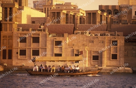 a city boat and ferry on the Dubai creek in the old town in the city of Dubai in the Arab Emirates in the Gulf of Arabia.