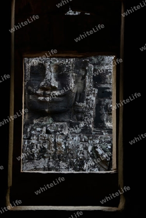 Stone Faces the Tempel Ruin of Angkor Thom in the Temple City of Angkor near the City of Siem Riep in the west of Cambodia.