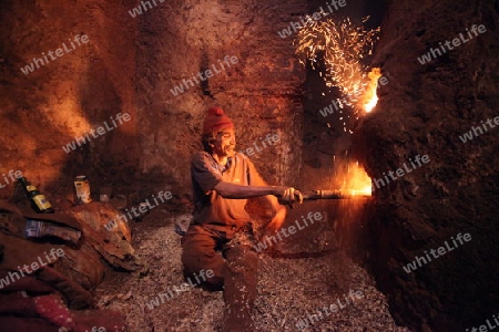 A men heat up Water for a Hammam or Arab Bath in the old City in the historical Town of Fes in Morocco in north Africa.