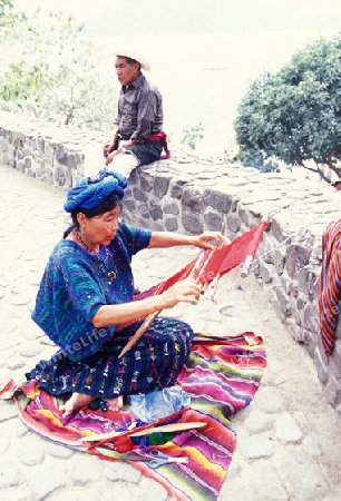 a women works in traditional clotes in the Village of  Panajachel in Guatemala in central America.   