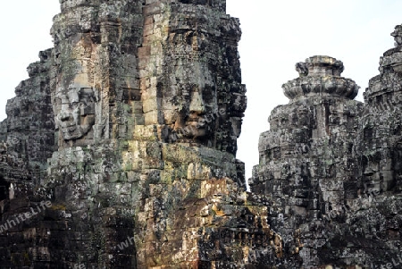 Stone Faces the Tempel Ruin of Angkor Thom in the Temple City of Angkor near the City of Siem Riep in the west of Cambodia.