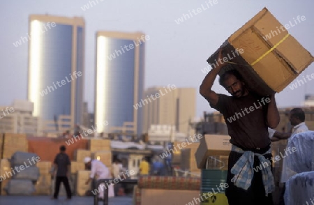 Import and export goods at the harbour at the Dubai creek in the old town in the city of Dubai in the Arab Emirates in the Gulf of Arabia.