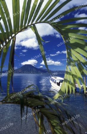 The Lake Atitlan mit the Volcanos of Toliman and San Pedro in the back at the Town of Panajachel in Guatemala in central America.   