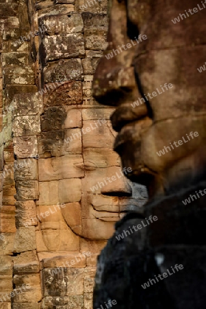 Stone Faces the Tempel Ruin of Angkor Thom in the Temple City of Angkor near the City of Siem Riep in the west of Cambodia.