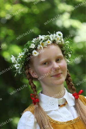 a Women in traditional dress on a Summer Festival in a Parc in the old City of Vilnius in the Baltic State of Lithuania,  