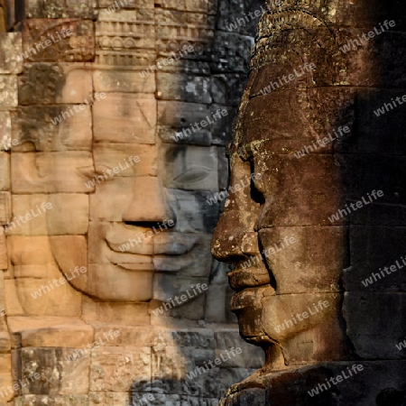 Stone Faces the Tempel Ruin of Angkor Thom in the Temple City of Angkor near the City of Siem Riep in the west of Cambodia.