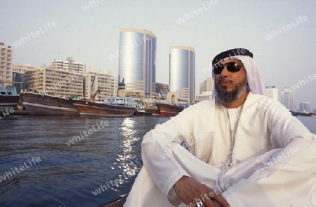 a city boat and ferry on the Dubai creek in the old town in the city of Dubai in the Arab Emirates in the Gulf of Arabia.