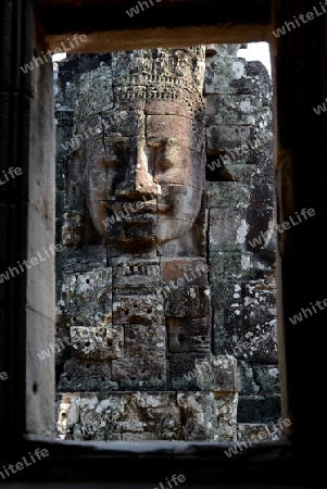 Stone Faces the Tempel Ruin of Angkor Thom in the Temple City of Angkor near the City of Siem Riep in the west of Cambodia.