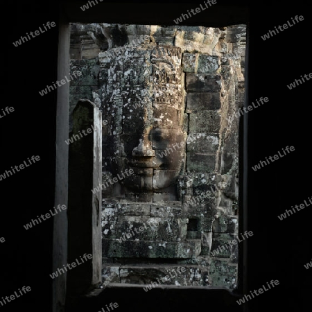 Stone Faces the Tempel Ruin of Angkor Thom in the Temple City of Angkor near the City of Siem Riep in the west of Cambodia.