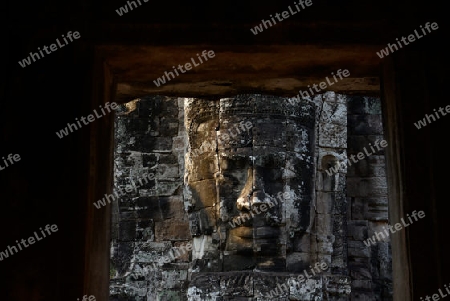 Stone Faces the Tempel Ruin of Angkor Thom in the Temple City of Angkor near the City of Siem Riep in the west of Cambodia.