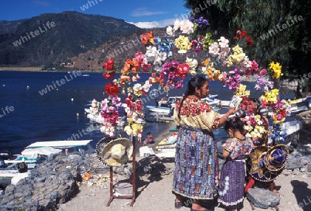 people at the Lake Atitlan mit the Volcanos of Toliman and San Pedro in the back at the Town of Panajachel in Guatemala in central America.   