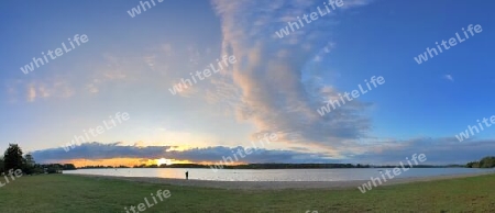 Beautiful high resolution panorama of a northern european country landscape with fields and green grass.