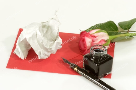 Rose mit Papier und Schreibutensilien