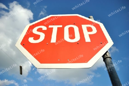 stop sign with lamp in the background