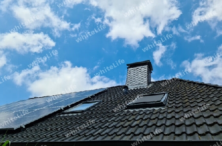 Solar panels producing clean energy on a roof of a residential house