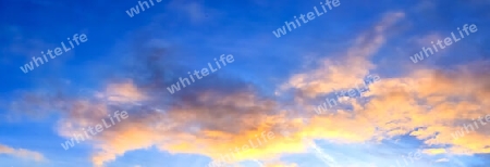 Beautiful high resolution panorama of orange and red sunset clouds in the evening sky.