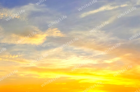 Beautiful high resolution panorama of orange and red sunset clouds in the evening sky.