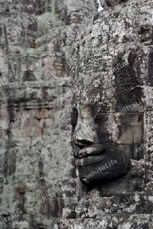 Stone Faces the Tempel Ruin of Angkor Thom in the Temple City of Angkor near the City of Siem Riep in the west of Cambodia.