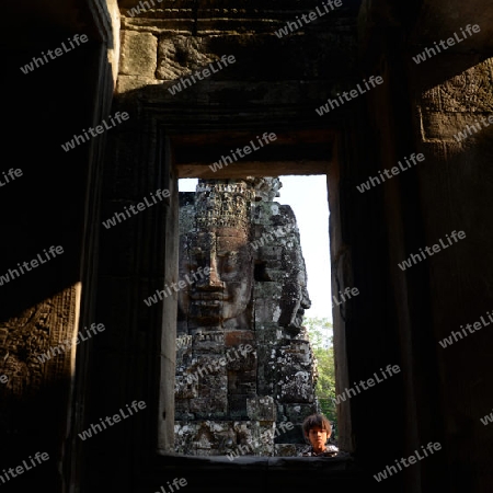 Stone Faces the Tempel Ruin of Angkor Thom in the Temple City of Angkor near the City of Siem Riep in the west of Cambodia.