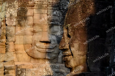 Stone Faces the Tempel Ruin of Angkor Thom in the Temple City of Angkor near the City of Siem Riep in the west of Cambodia.