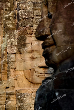 Stone Faces the Tempel Ruin of Angkor Thom in the Temple City of Angkor near the City of Siem Riep in the west of Cambodia.