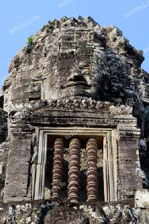 Stone Faces the Tempel Ruin of Angkor Thom in the Temple City of Angkor near the City of Siem Riep in the west of Cambodia.