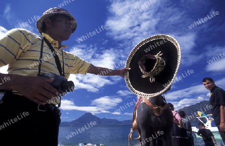 The Lake Atitlan mit the Volcanos of Toliman and San Pedro in the back at the Town of Panajachel in Guatemala in central America.   