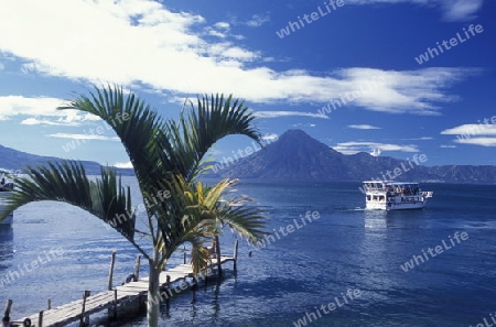 The Lake Atitlan mit the Volcanos of Toliman and San Pedro in the back at the Town of Panajachel in Guatemala in central America.   