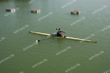 Young man rowing in canal