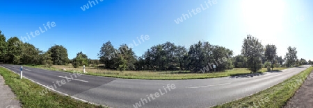 Beautiful high resolution panorama of a northern european country landscape with fields and green grass.