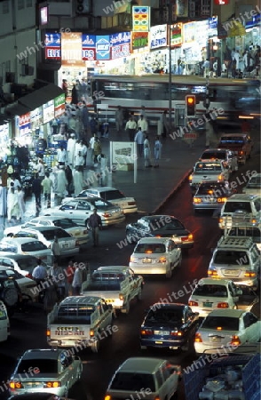 a road at night in the old town in the city of Dubai in the Arab Emirates in the Gulf of Arabia.