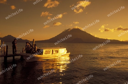 The Lake Atitlan mit the Volcanos of Toliman and San Pedro in the back at the Town of Panajachel in Guatemala in central America.   