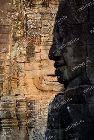 Stone Faces the Tempel Ruin of Angkor Thom in the Temple City of Angkor near the City of Siem Riep in the west of Cambodia.