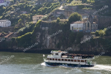 a boat on the Douro River in Ribeira in the city centre of Porto in Porugal in Europe.