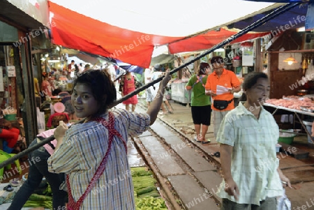 the Maeklong Railway Markt at the Maeklong railway station  near the city of Bangkok in Thailand in Suedostasien.