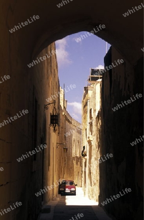 A smal road in the centre of the Old Town of the city of Valletta on the Island of Malta in the Mediterranean Sea in Europe.
