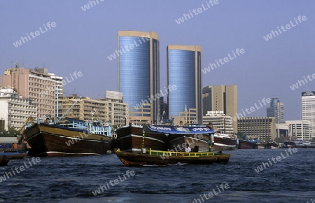 a city boat and ferry on the Dubai creek in the old town in the city of Dubai in the Arab Emirates in the Gulf of Arabia.