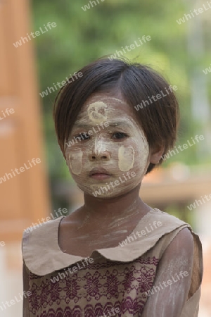 a girl with the thanaka cosmetic at the Mahagandayon Monastery in Amarapura near the City of Mandalay in Myanmar in Southeastasia.