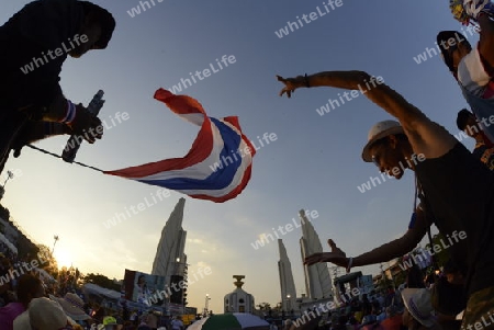 Thai anti-government protesters wave national flags during a rally at theDemocracy Monument in .Bangkok, Thailand, Saturday Jan.11 , 2014.