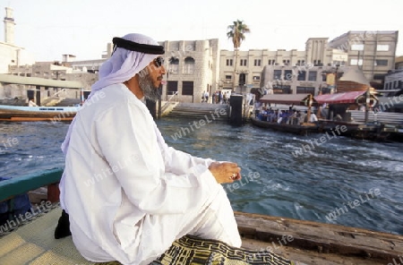 a city boat and ferry on the Dubai creek in the old town in the city of Dubai in the Arab Emirates in the Gulf of Arabia.