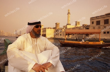 a city boat and ferry on the Dubai creek in the old town in the city of Dubai in the Arab Emirates in the Gulf of Arabia.