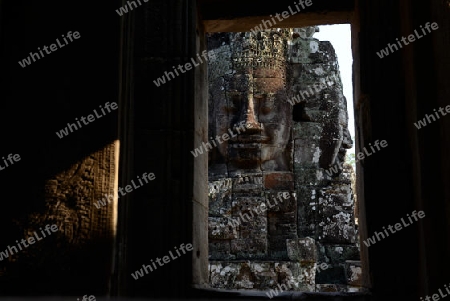 Stone Faces the Tempel Ruin of Angkor Thom in the Temple City of Angkor near the City of Siem Riep in the west of Cambodia.