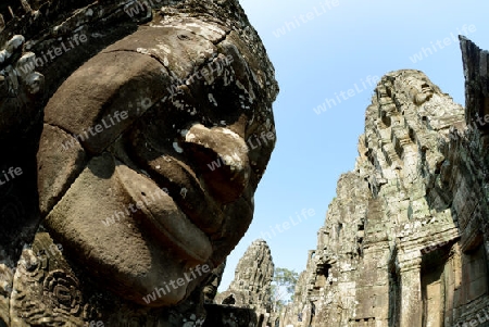 Stone Faces the Tempel Ruin of Angkor Thom in the Temple City of Angkor near the City of Siem Riep in the west of Cambodia.