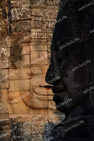 Stone Faces the Tempel Ruin of Angkor Thom in the Temple City of Angkor near the City of Siem Riep in the west of Cambodia.