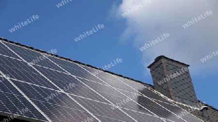 Solar panels producing clean energy on a roof of a residential house